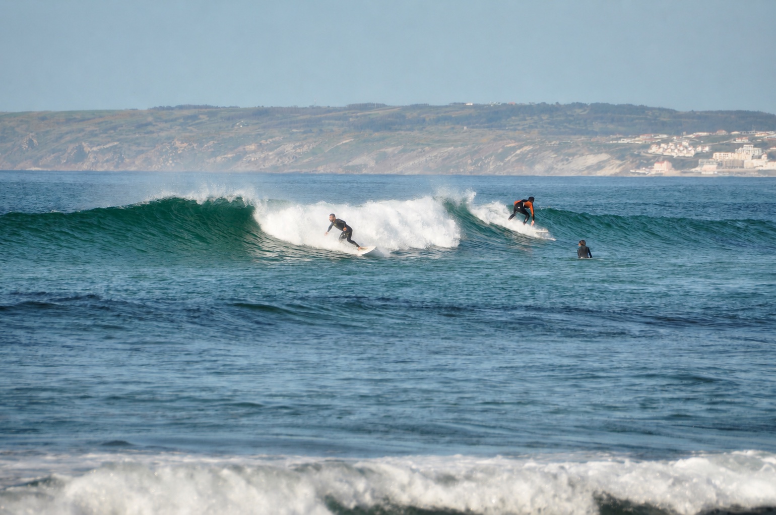 Surfers riding clean waves at Lagide on the north side of Baleal