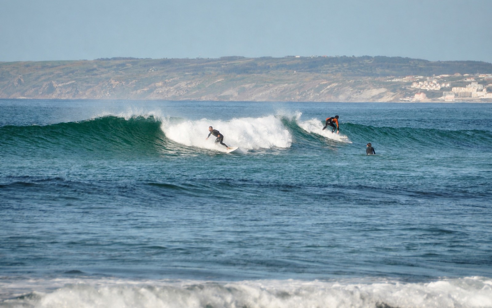 Surfers riding Atlantic waves at Lagide near Baleal
