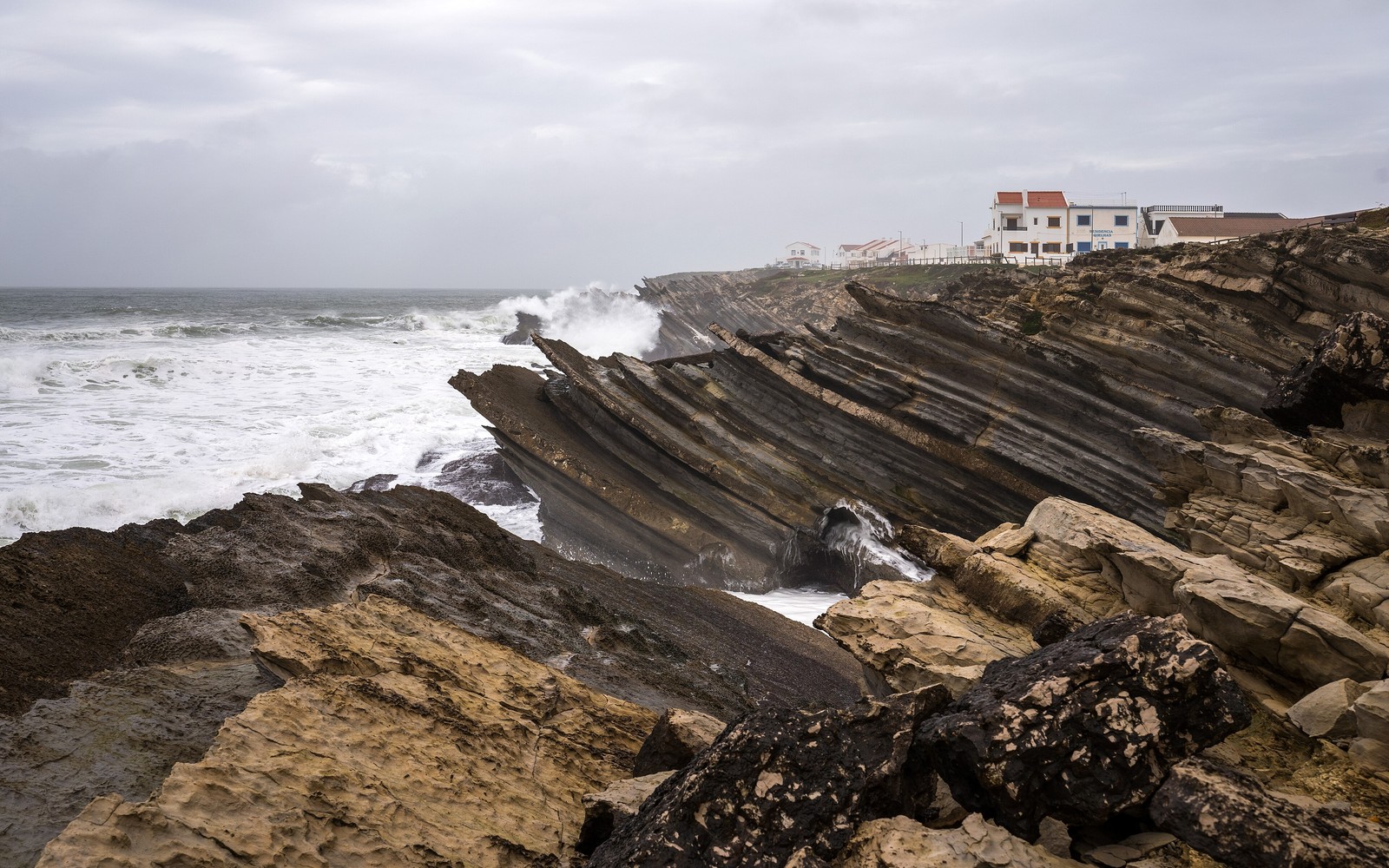 Layered rock formations and Atlantic waves at Baleal