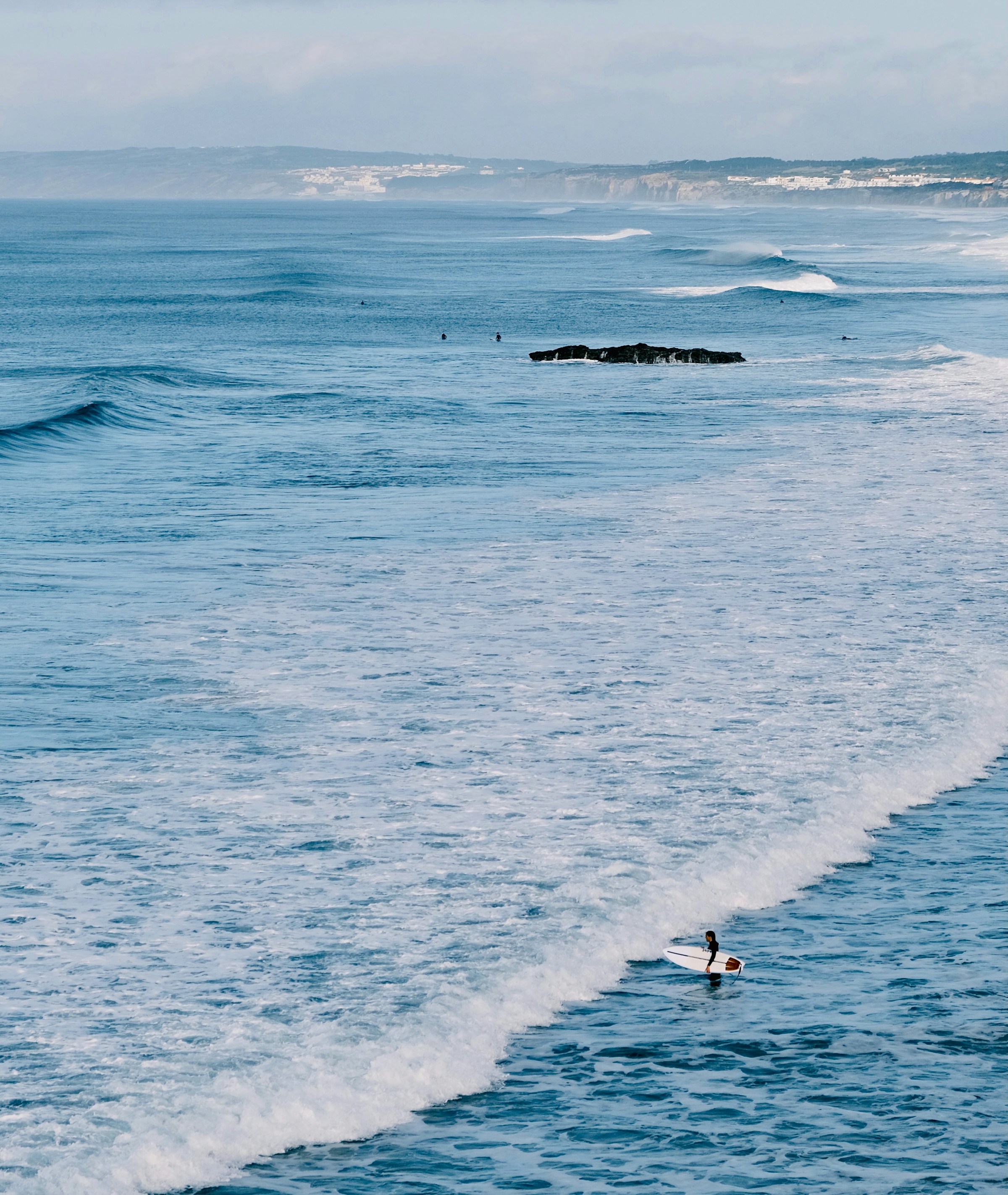 Surfer riding an Atlantic wave in Peniche