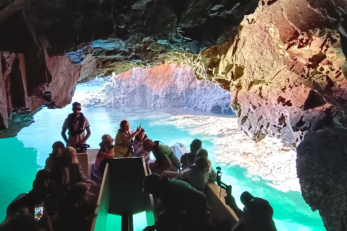 Catamaran passengers visiting a sea cave in the Berlengas