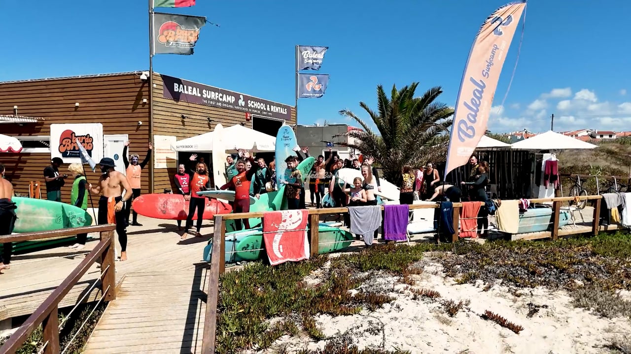 Surfers gathered with boards outside Baleal Surf Camp