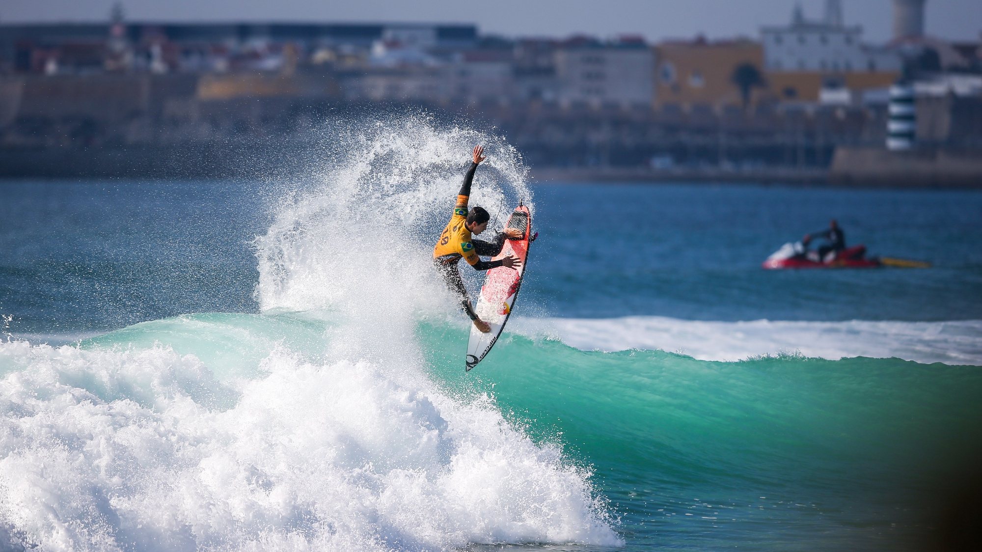 Surfer performing an aerial manoeuvre during competition in Peniche
